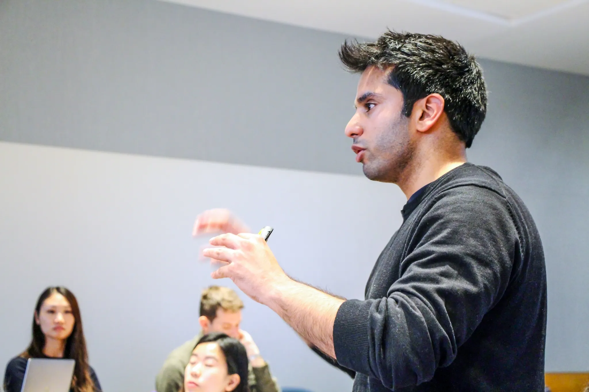 Hassan Akram mid-explanation during an invited session in an MIT Sloan student-led context.