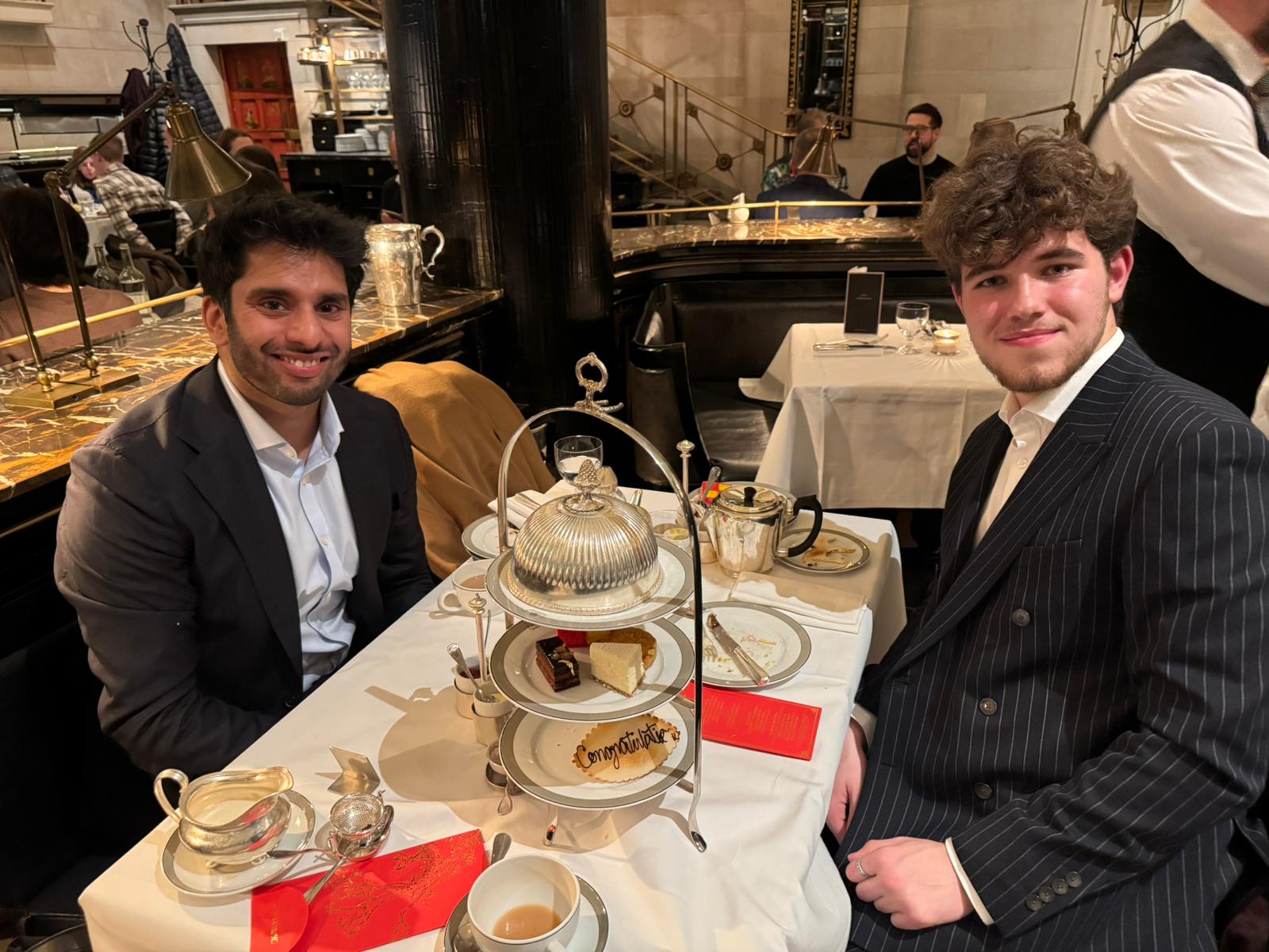 Hassan and Matei celebrating Clifford Chance training contract